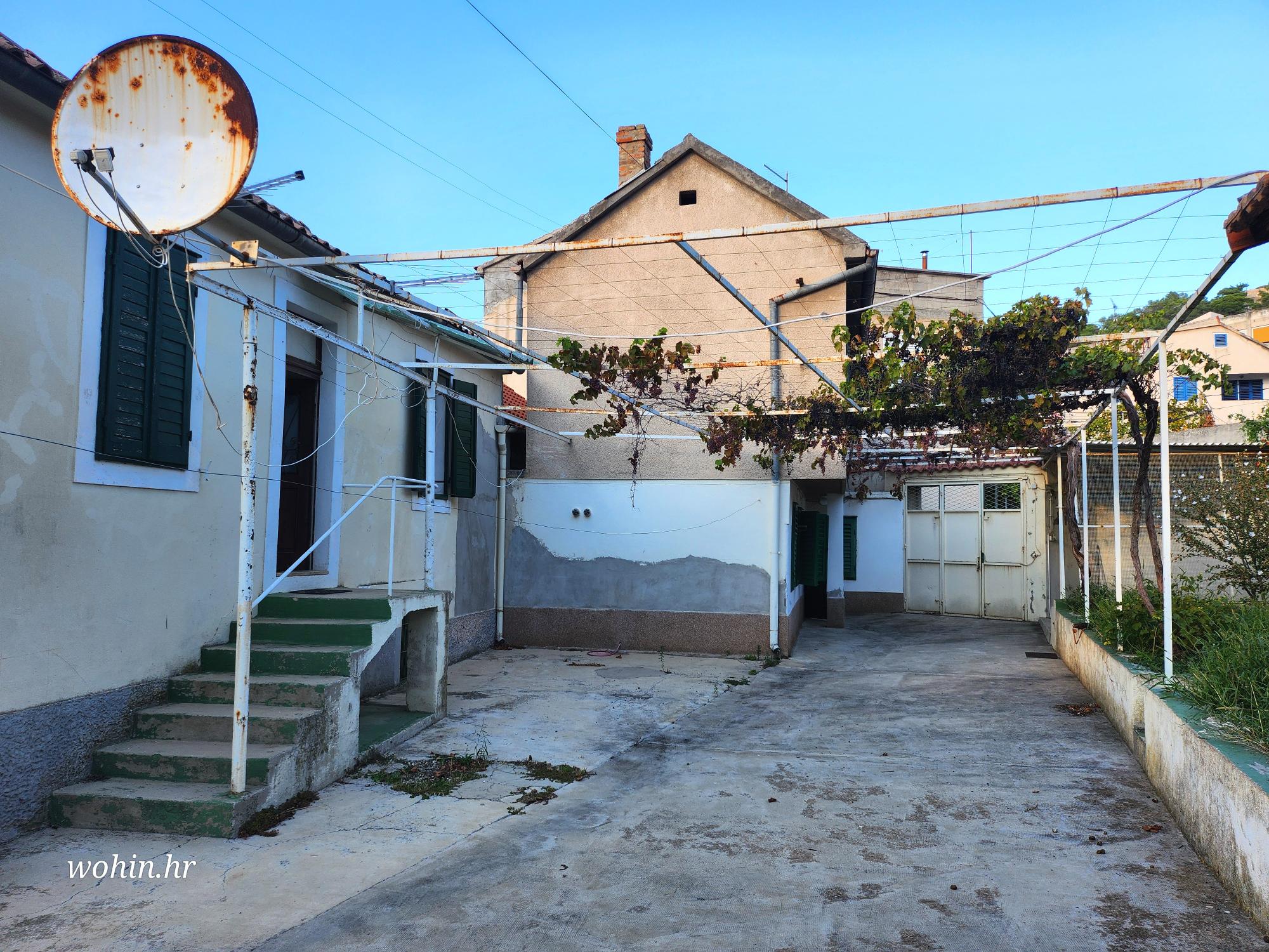 Two houses with a large yard in the city